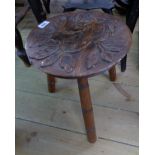 A 19th Century varnished wood ornamental milking stool with carved oak leaf decoration to top, set