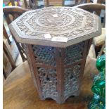 A 12" carved wood Moorish style occasional table with carved decoration to top and ornate pierced