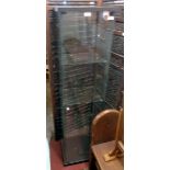 A 16 3/4" modern glazed pedestal display cabinet with three glass shelves and locking door with
