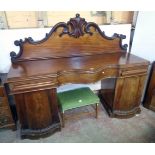 A 6' 8" Victorian mahogany break serpentine front twin pedestal sideboard with ornate raised