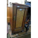 A 15" late Victorian walnut pot cupboard enclosed by a burr panelled door, set on shaped bracket