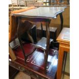 A 26" early 20th Century stained mixed wood two tier occasional table, set on slender cabriole