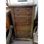 A 20" Victorian mahogany Wellington chest with flight of seven graduated drawers, set on plinth base