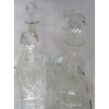 Four decanters comprising cut glass spirit and three Edwardian onion pattern examples
