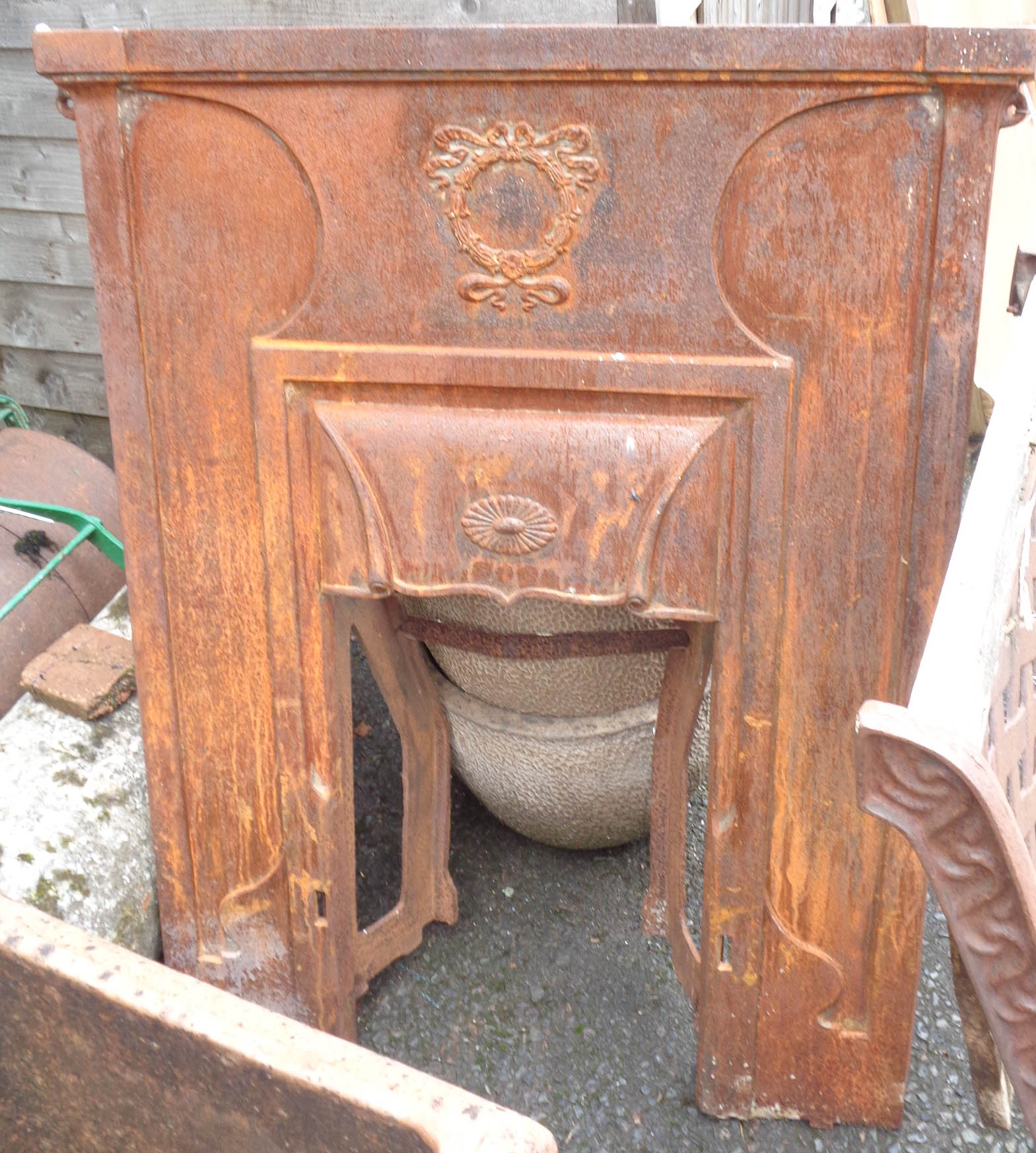 A cast iron fireplace insert - sold with a cast fire fender