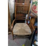 A 19th Century stained beech framed elbow chair with bobbin turned stick back and woven rush seat,