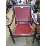 An Edwardian walnut and strung panel back elbow chair with swept armrests and remains of velour