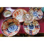 Two Imari plates and bowls, a Kutani plate, and a modern Imari style plate