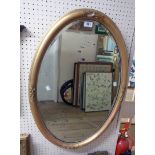 A 32" antique gilt gesso framed bevelled oval mirror - slight damage