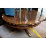 A 36" diameter reproduction quarter veneered and cross banded mixed wood coffee table with glass top