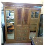 A 6' 4" Edwardian mahogany and strung wardrobe with moulded cornice, central two door cupboard and
