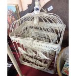 A graduated set of three mesh bird cages