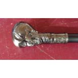 A modern reproduction walking stick with cast metal skull pattern top