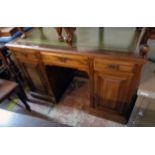 A 4' Edwardian mahogany kneehole desk with green leather inset top, three frieze drawers and