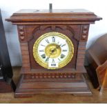 A late 19th Century stained oak cased American shelf clock with decorative dial, bezel and Ansonia