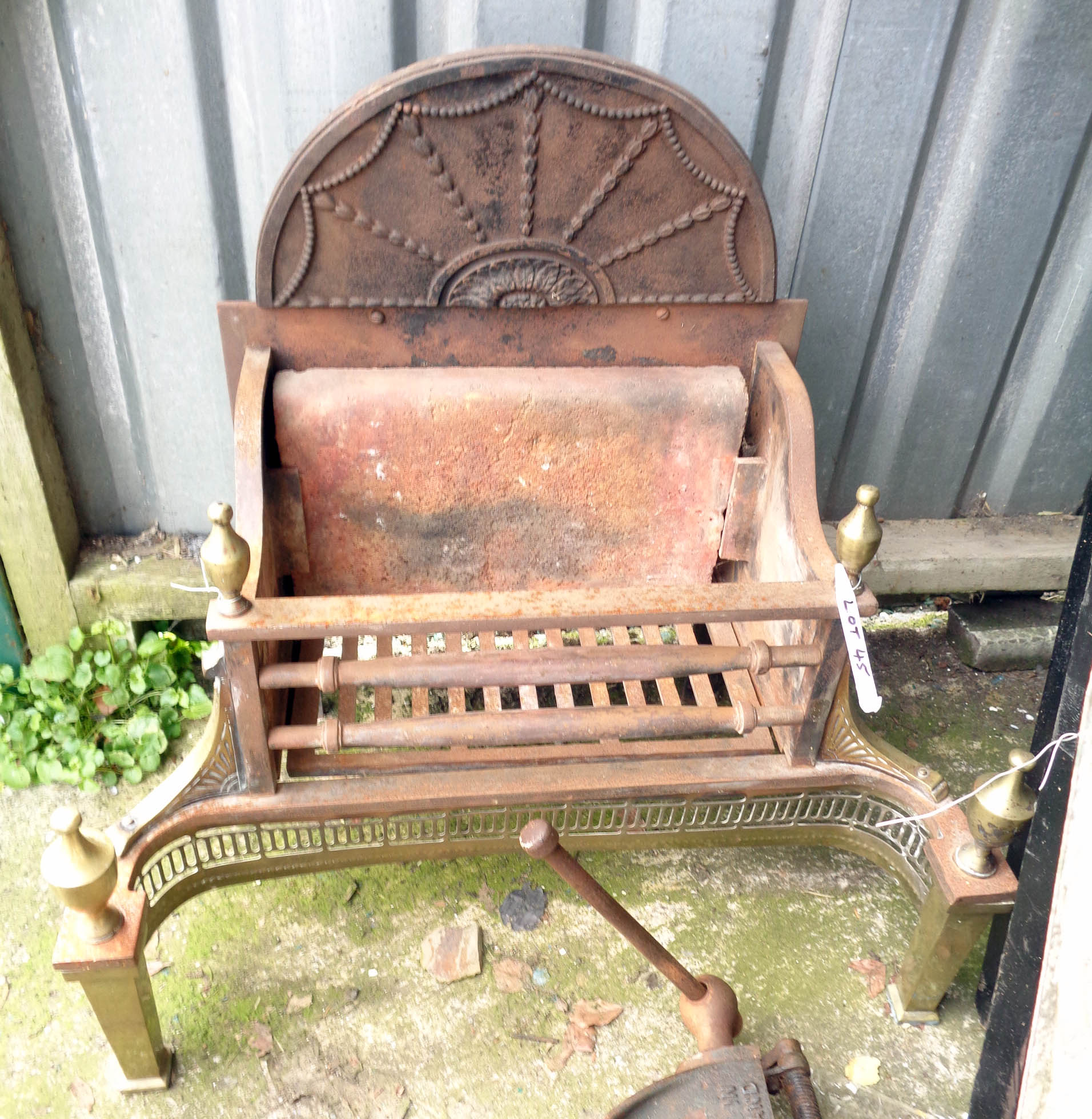 A cast iron and brass fire grate