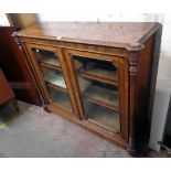 A 4' 2" 19th Century rosewood display cabinet with velvet lined shelves enclosed by a pair of glazed