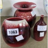 Three David White studio pottery vases of various design and red lustre glaze - one damaged