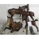 A Beswick horse and two foals - sold with a Royal Doulton foal (chip to ear)