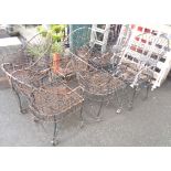 A set of six ornate wrought metal garden chairs
