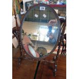 A 20th Century stained wood framed antique style dressing table mirror with oval plate and slender