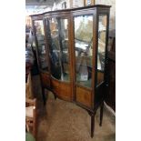 A 3' 11" Edwardian inlaid mahogany break bow front display cabinet with adapted mirror set back