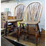 An antique wheel back kitchen chair with solid elm seat, set on ring turned supports - sold with