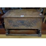 A 24" antique oak locker stool with carved decoration to sloping sides, set on turned supports and