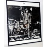 A framed black and white reprint photograph of Peter Cook