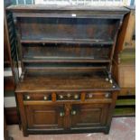 A 4' 4 1/2" antique oak two part dresser with moulded cornice and two shelf open plate rack, over