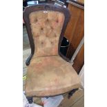 A late Victorian walnut part show frame nursing chair with remains of button back upholstery, set on