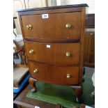 An 18" reproduction mahogany and mixed wood bow front bedside chest of three long drawers, set on