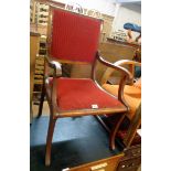 A 20th Century mahogany framed sabre leg elbow chair with studded upholstery