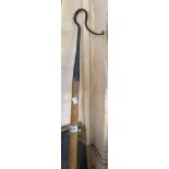A vintage blacksmith made wrought metal shepherd's crook with wooden handle