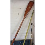 A vintage sweep-oar with wall brackets