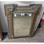 A Victorian stepped gilt framed ornate wall mirror with bevelled oblong plate and moulded acanthus