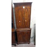 A 23 1/2" Bevan Funnell "Reprodux" flame mahogany veneered corner cupboard with two pairs of