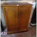 A 27" early 20th Century mahogany cabinet with three shelves enclosed by a pair of beaded panelled