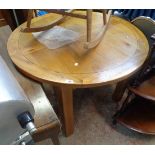 A 3' 7 1/2" diameter 20th Century oak and mixed wood extending dining table with stowed folding leaf