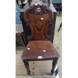 A Victorian mahogany shield back hall chair with C-scroll decoration and moulded seat, set on turned