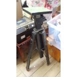 A vintage Gandolfi photographic tripod with hand wind height adjuster