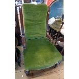 A late Victorian moulded walnut part show frame nursing chair with green velour upholstery to back