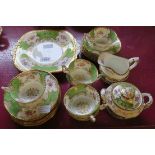 A Coalport Panel Apple Green pattern six place tea set, comprising six trios, bread plate, milk