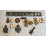 A bag containing various military, Civil Defense and ARP items including Air Raid Warden door