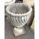 A concrete garden urn with wrythen decoration