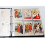 A box sleeved album containing a collection of early 20th Century postcards including numerous