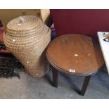 A 20th Century polished oak circular occasional table - sold with an "Ali Baba" laundry basket and a
