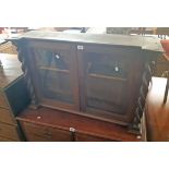 A 3' 2 1/2" antique mahogany break front glazed cabinet top with flanking barley twist pillars and