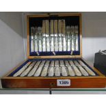 An Edwardian mahogany and strung cased set of eighteen each silver plated fruit knives and forks