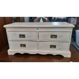 A 29 1/2" painted pine low chest of four flanking short drawers with brass flush handles, set on